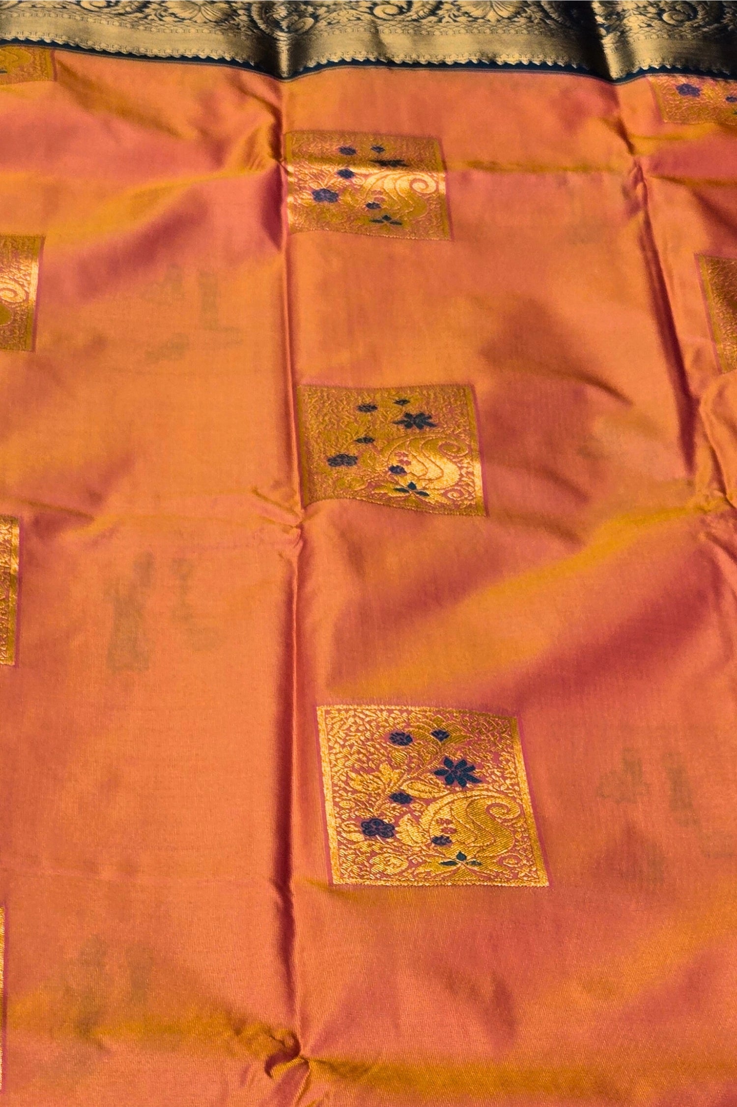 Traditional saree with gold embroidery on a pink background