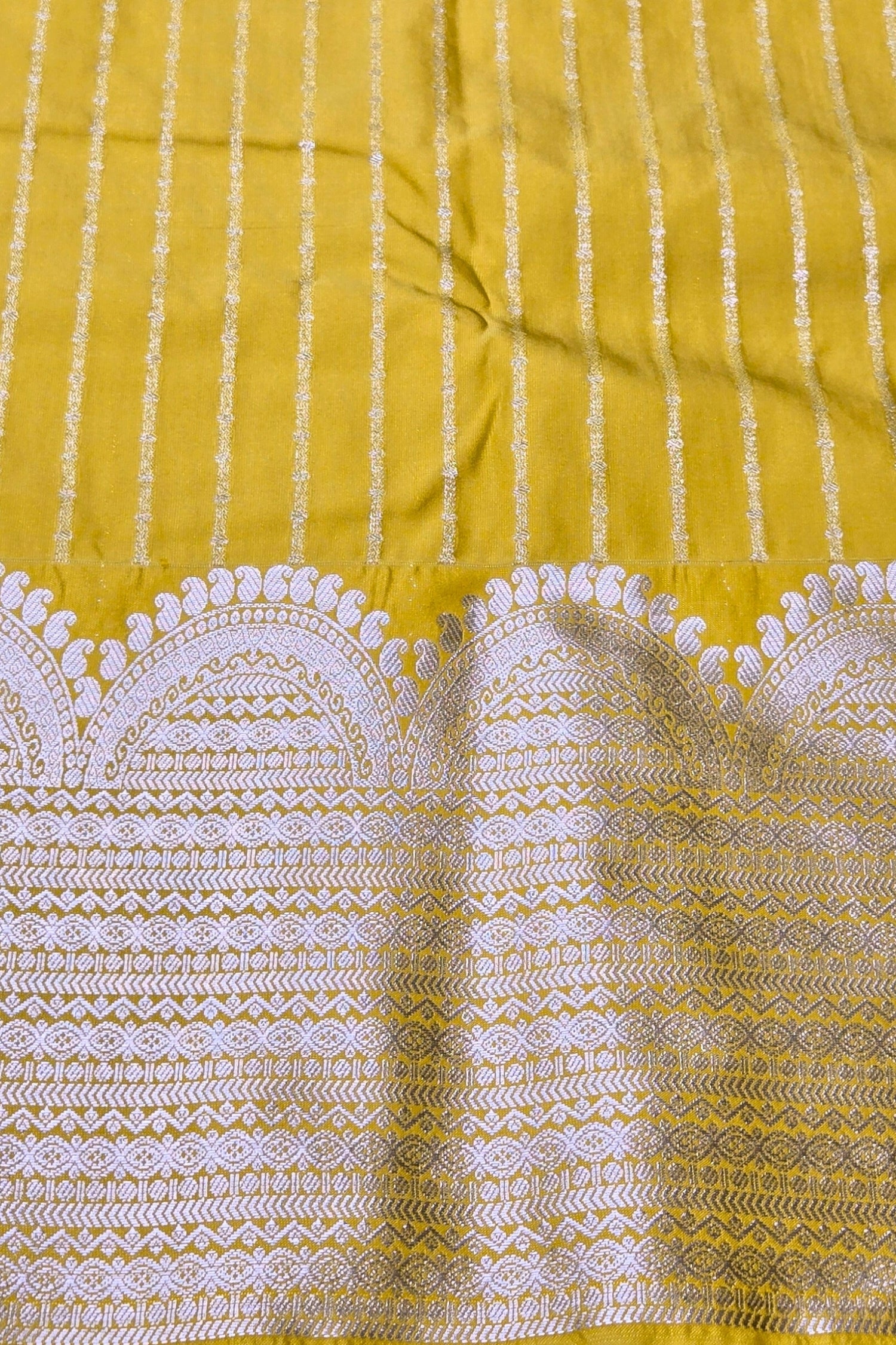 Yellow fabric with white intricate patterns
