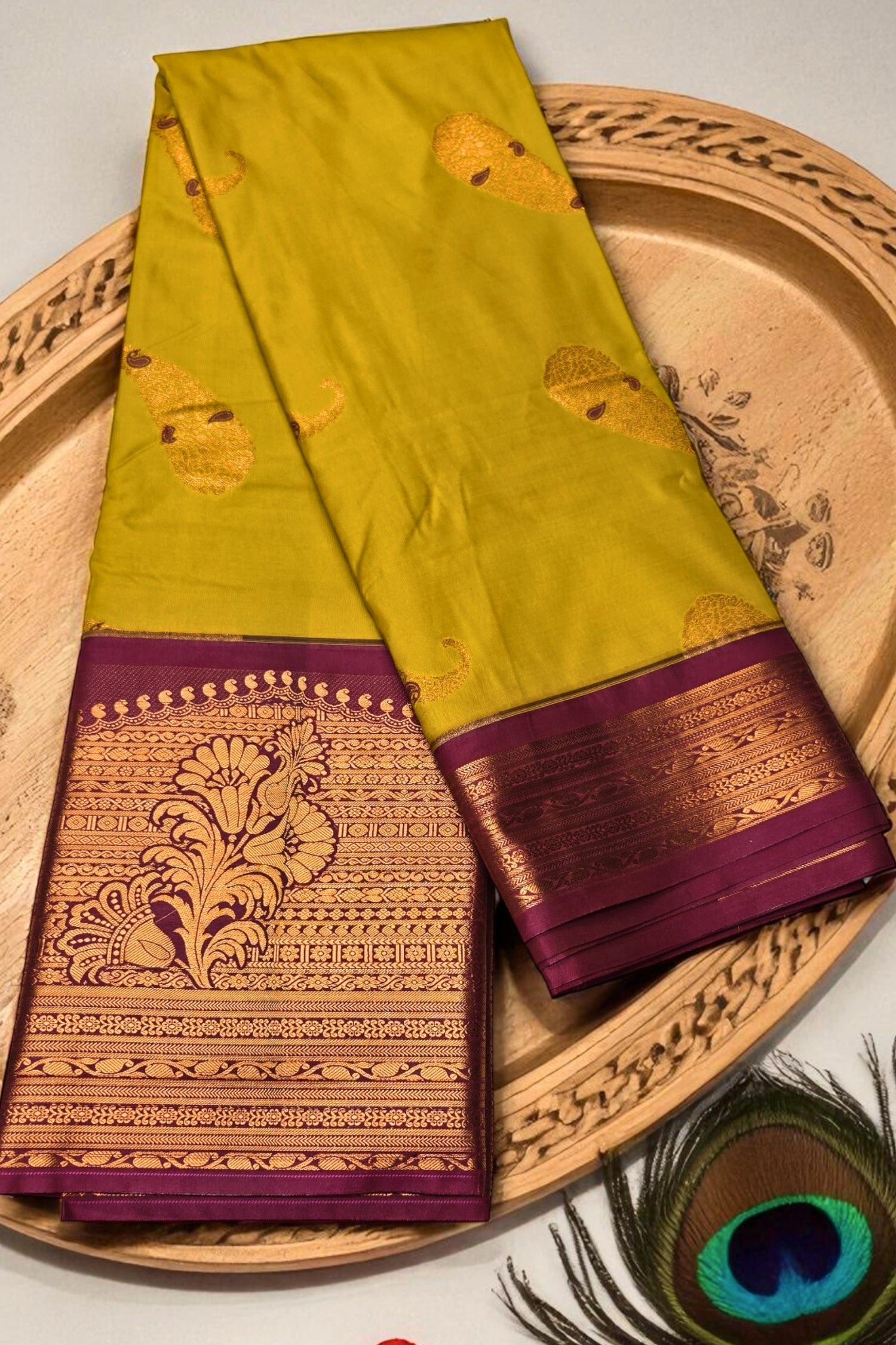 Green and purple saree with intricate patterns on a decorative plate