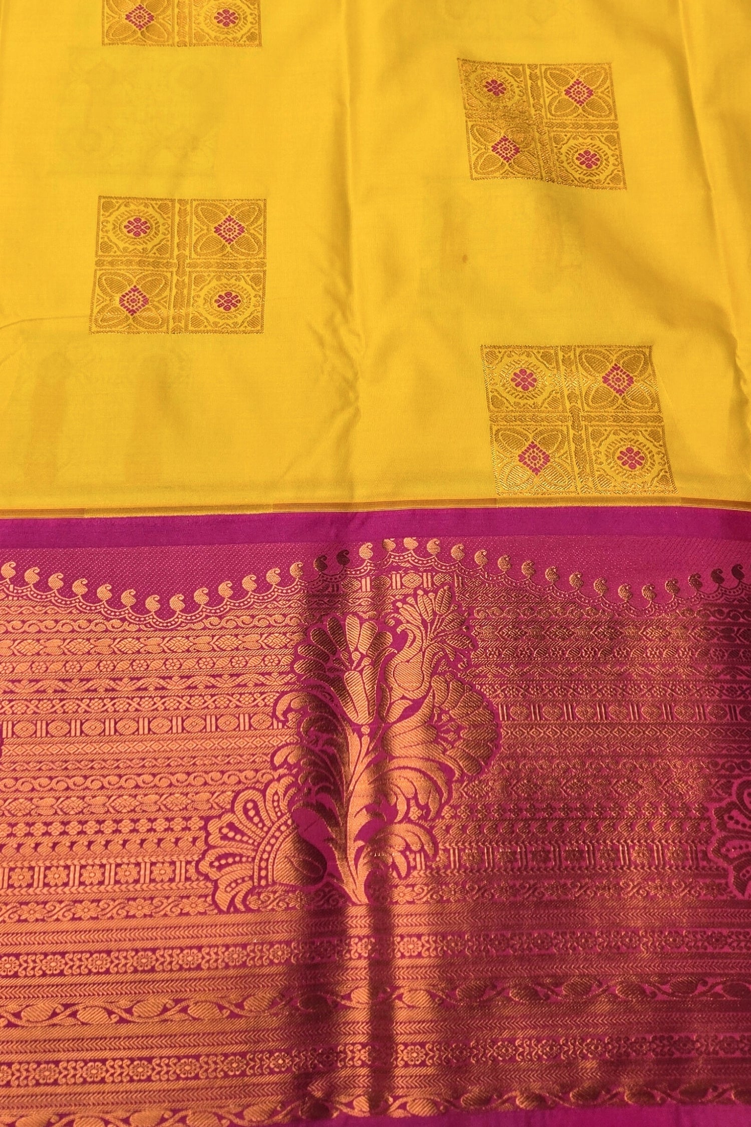 Yellow and purple traditional fabric with intricate patterns