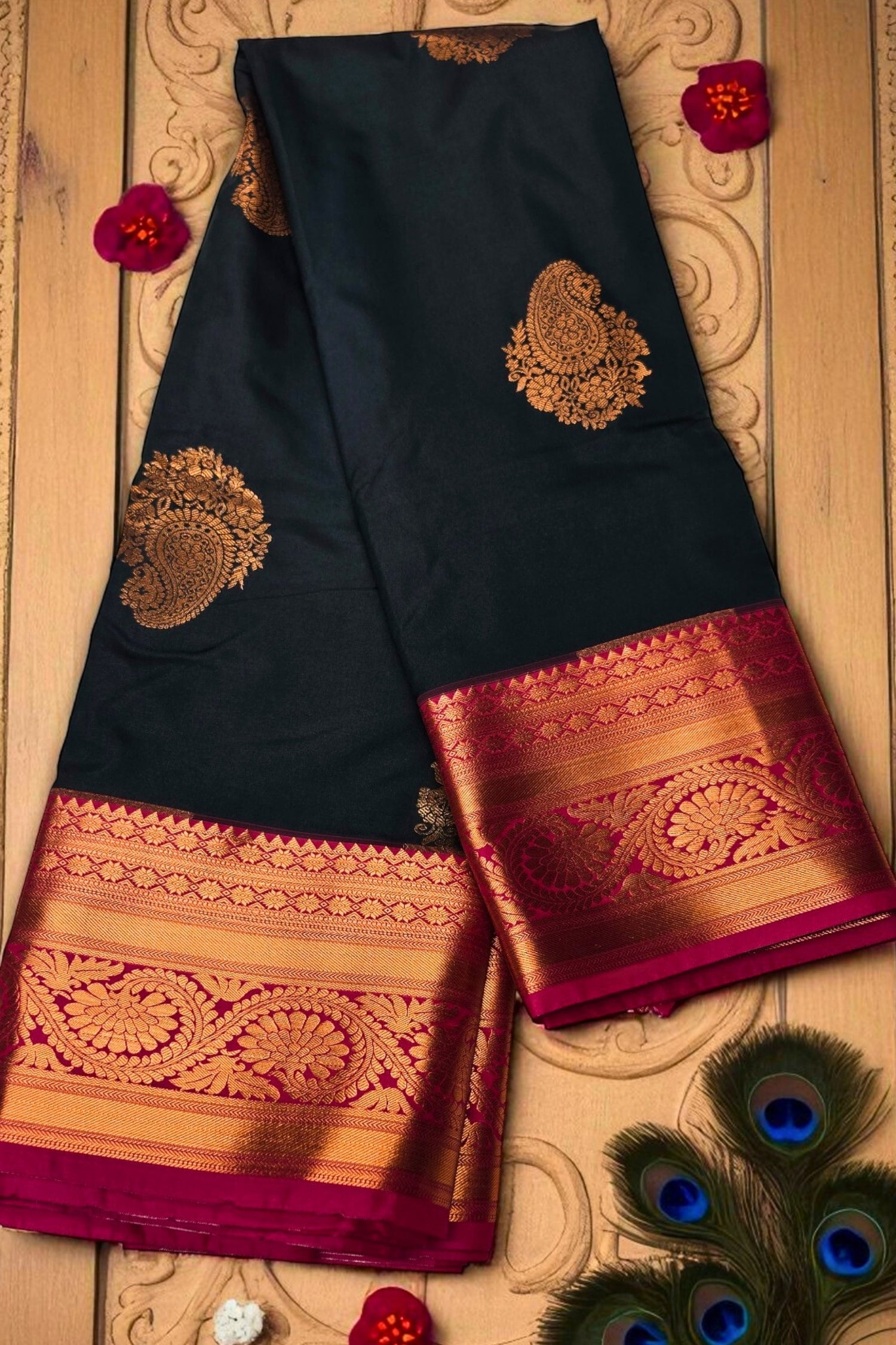 Black saree with gold and red border on a decorative background