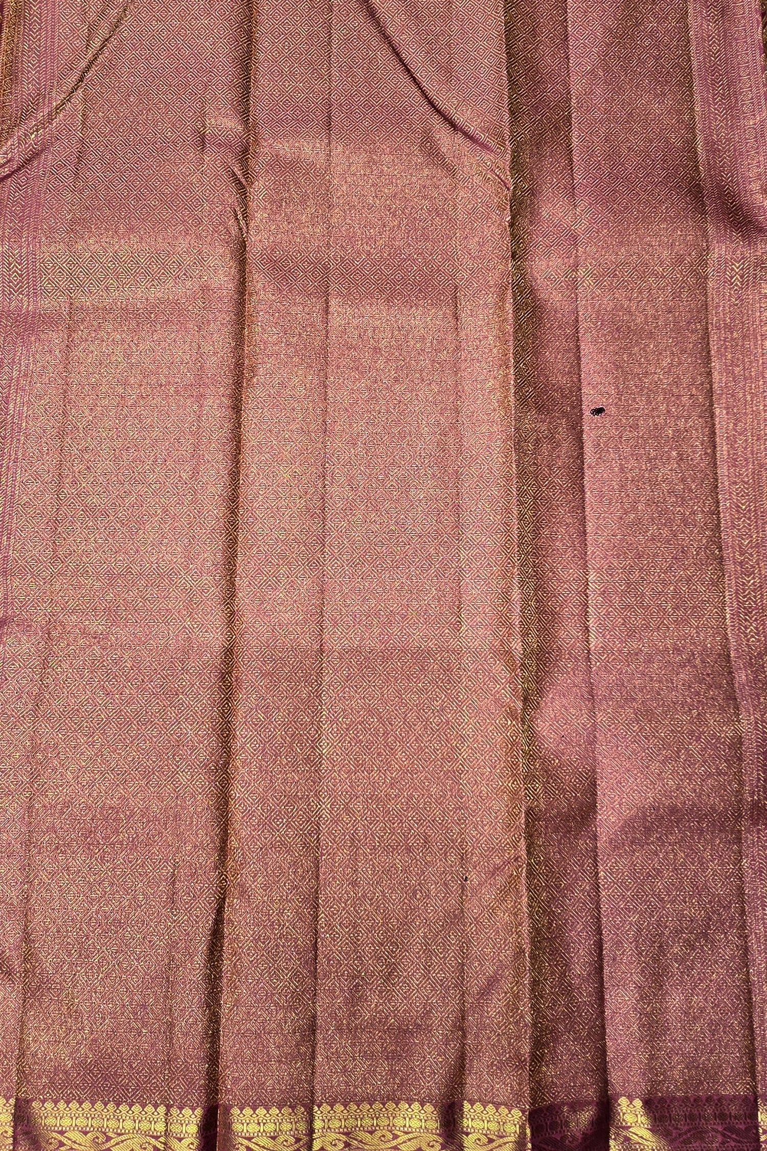 Close-up of a fabric with a checkered pattern and gold border.
