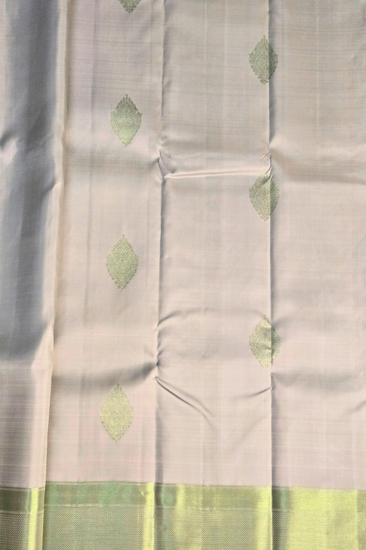 Close-up of white Kanchipuram silk fabric with soft sheen