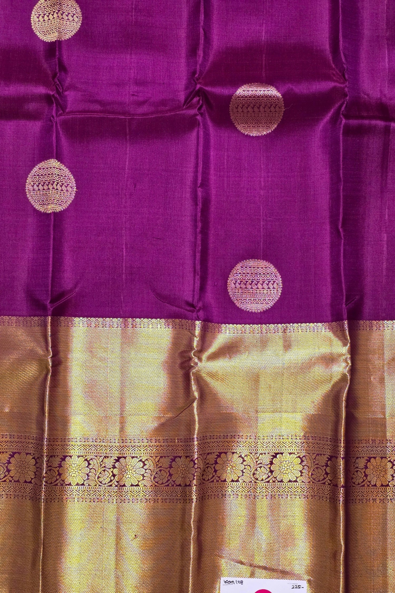 Purple and gold traditional fabric with circular patterns