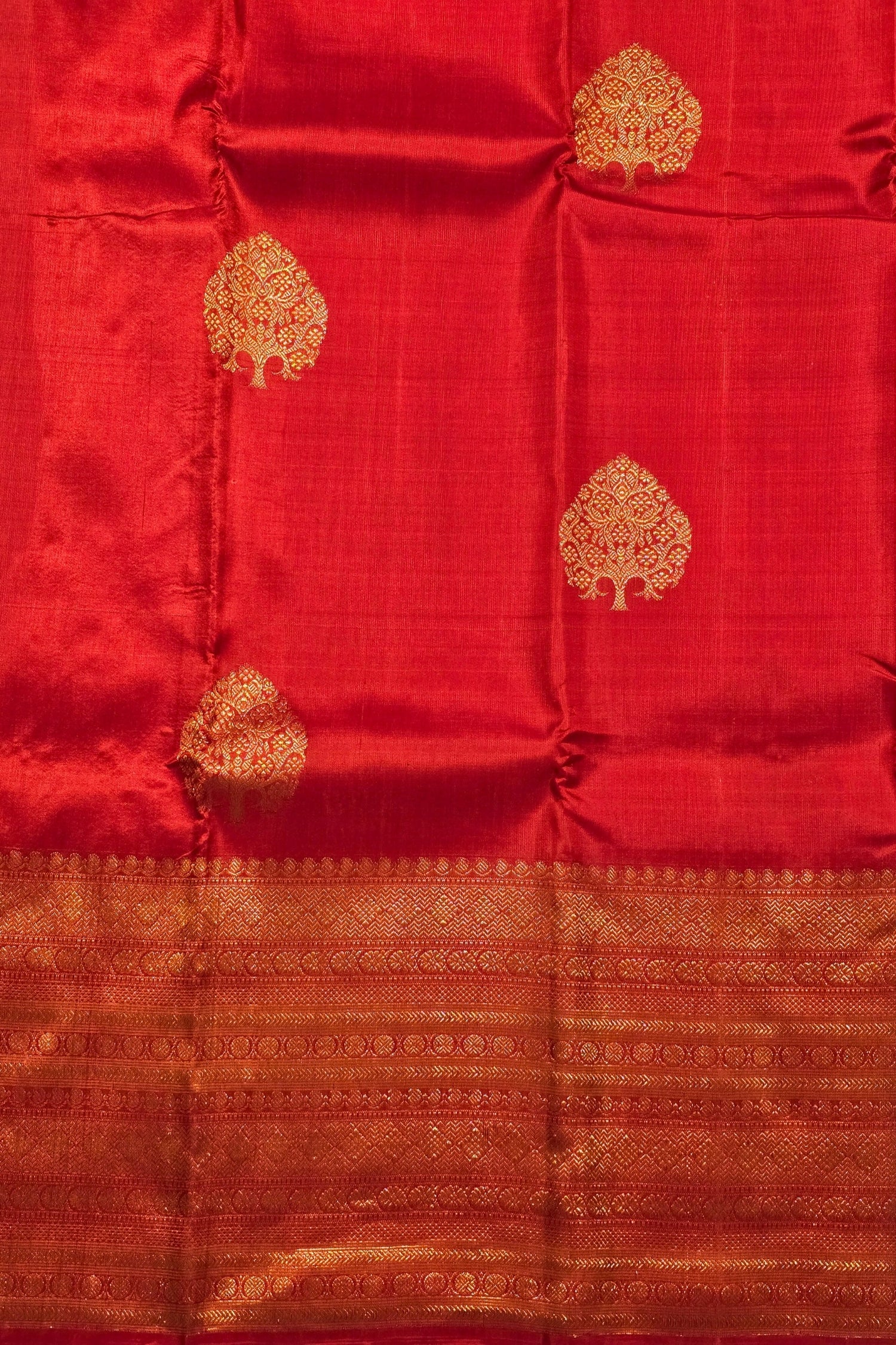 Red fabric with gold tree patterns