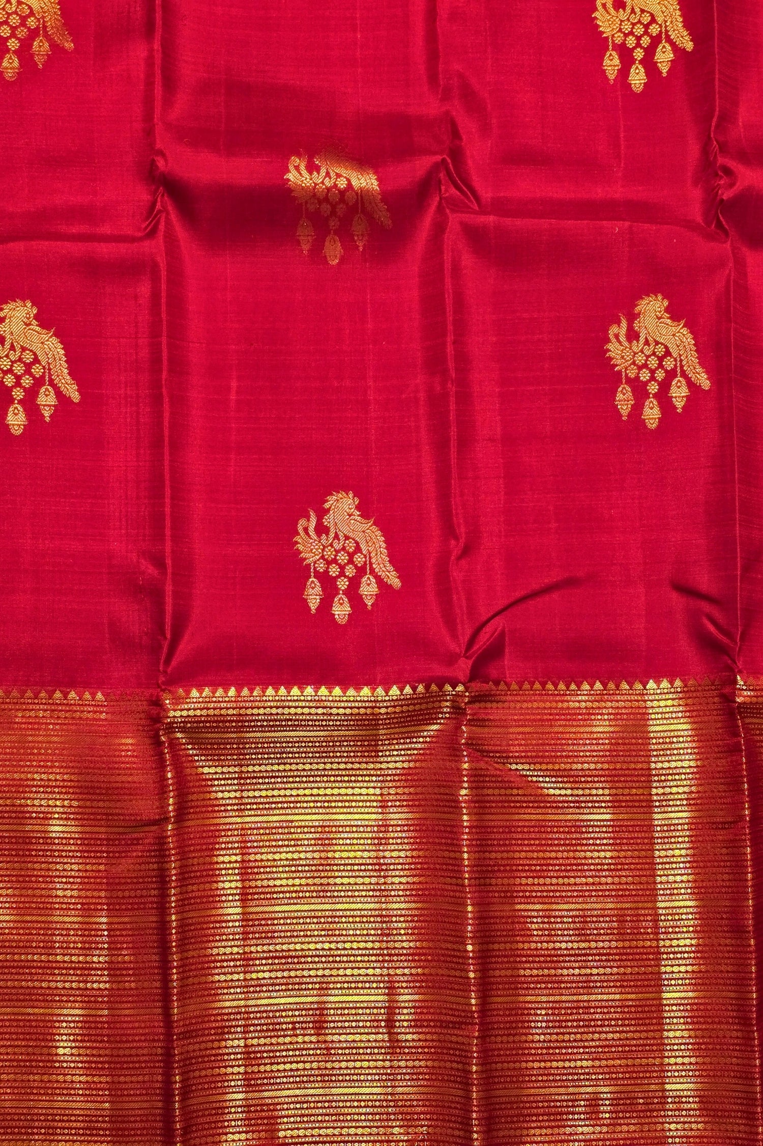 Red fabric with gold patterns and border