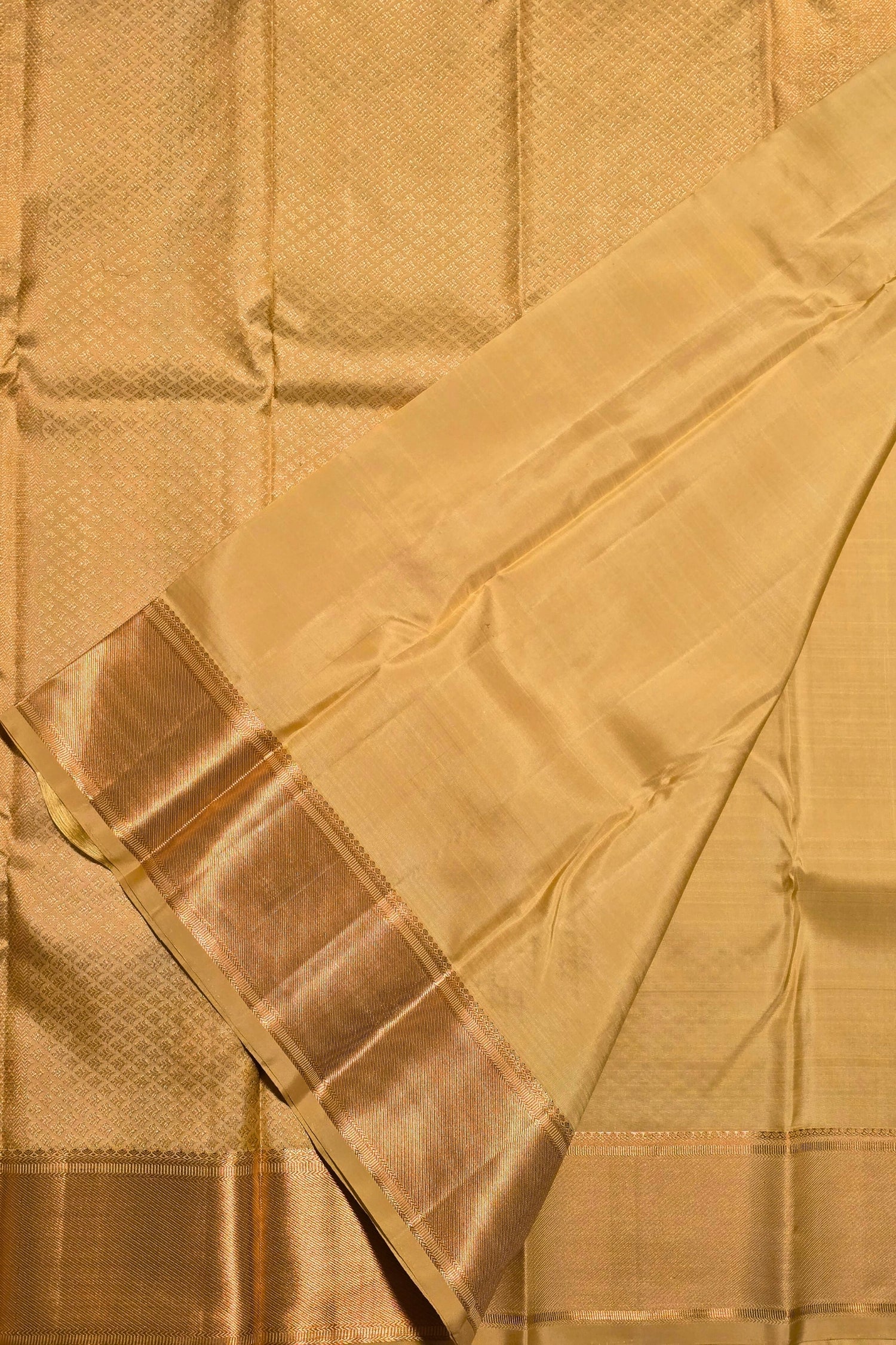 Traditional golden saree with rich border and shimmering pallu