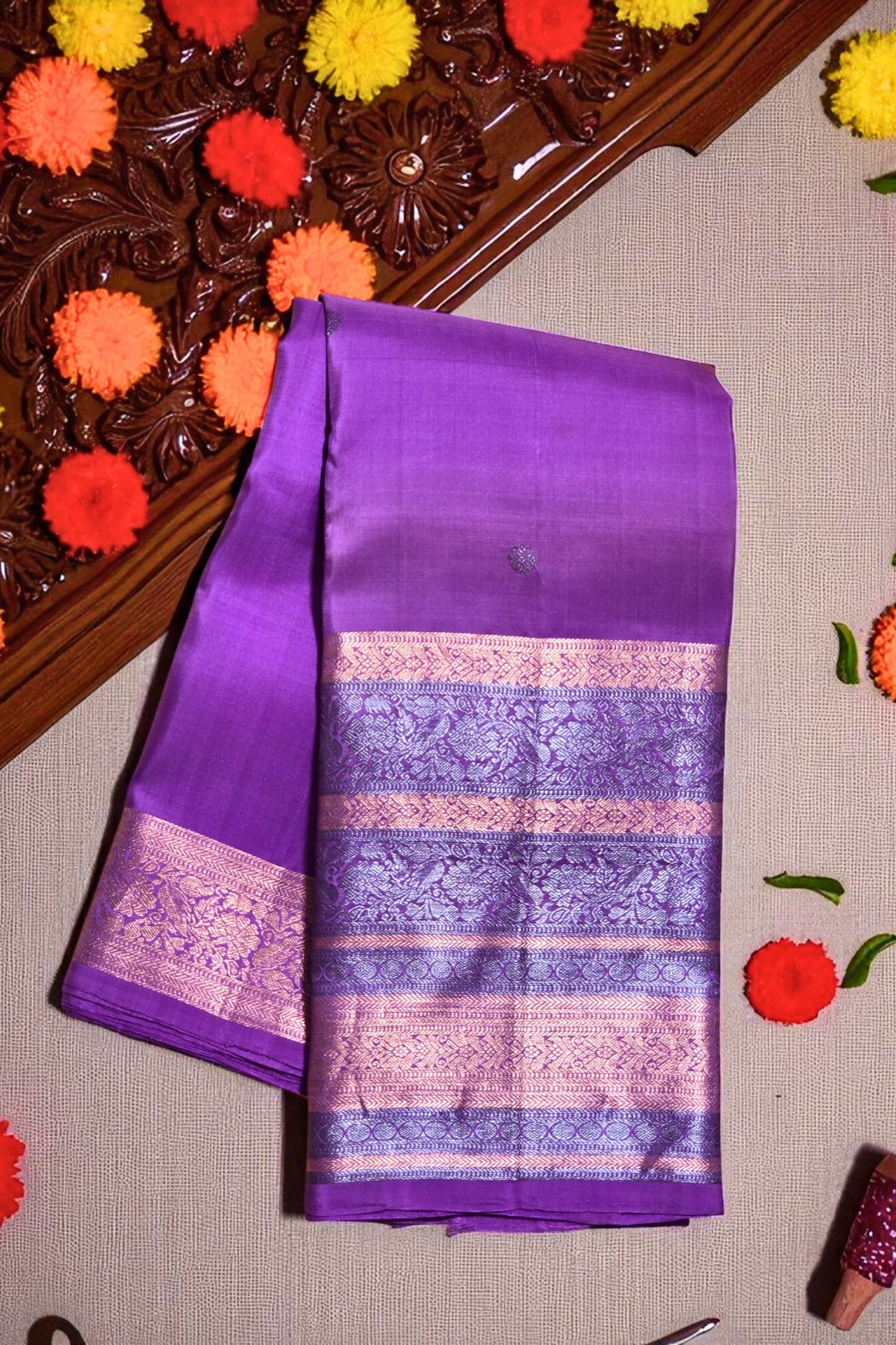 Purple saree with pink and white border on a decorative background