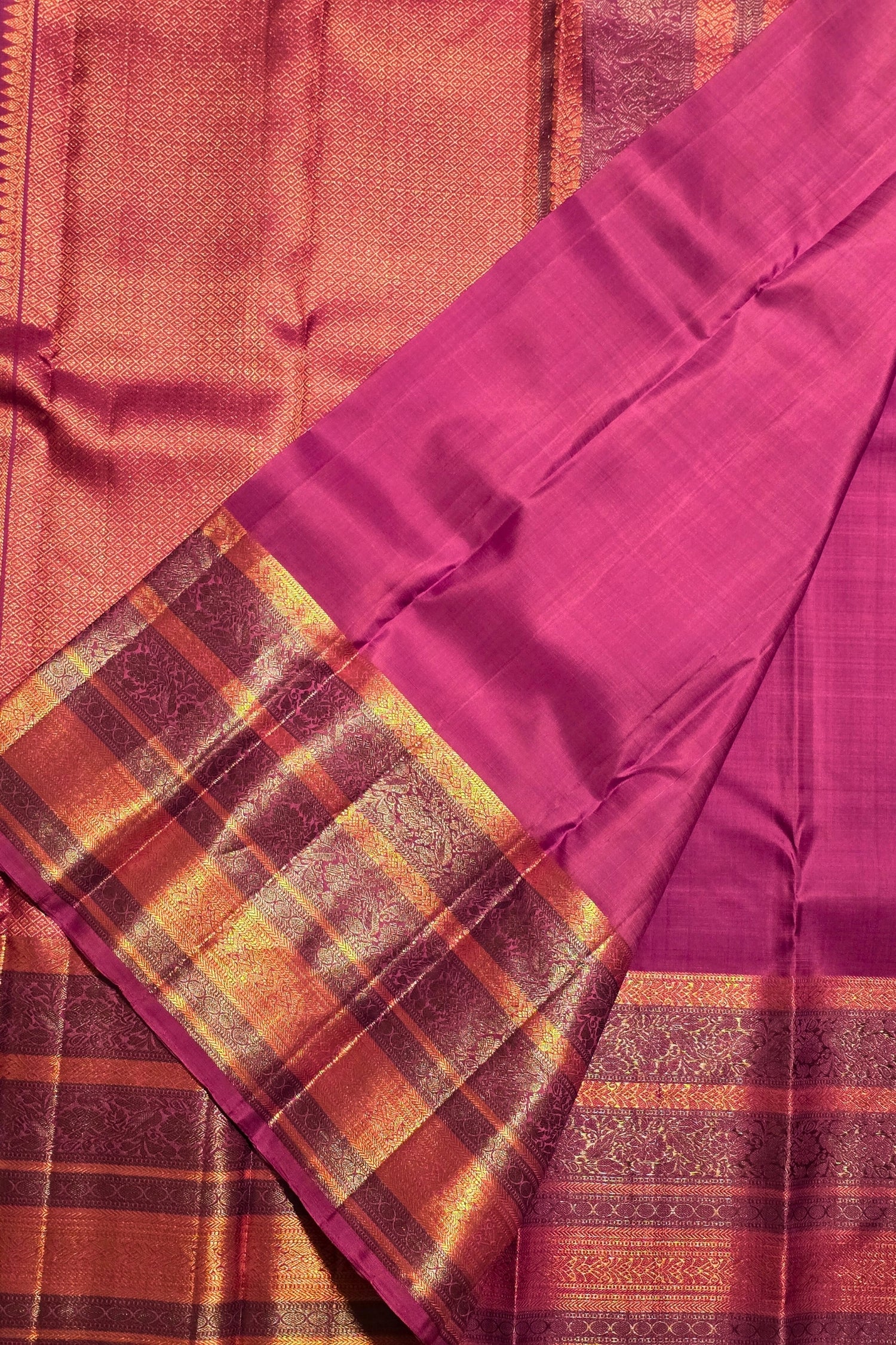Close-up of a saree with a checkered pattern and a purple border.