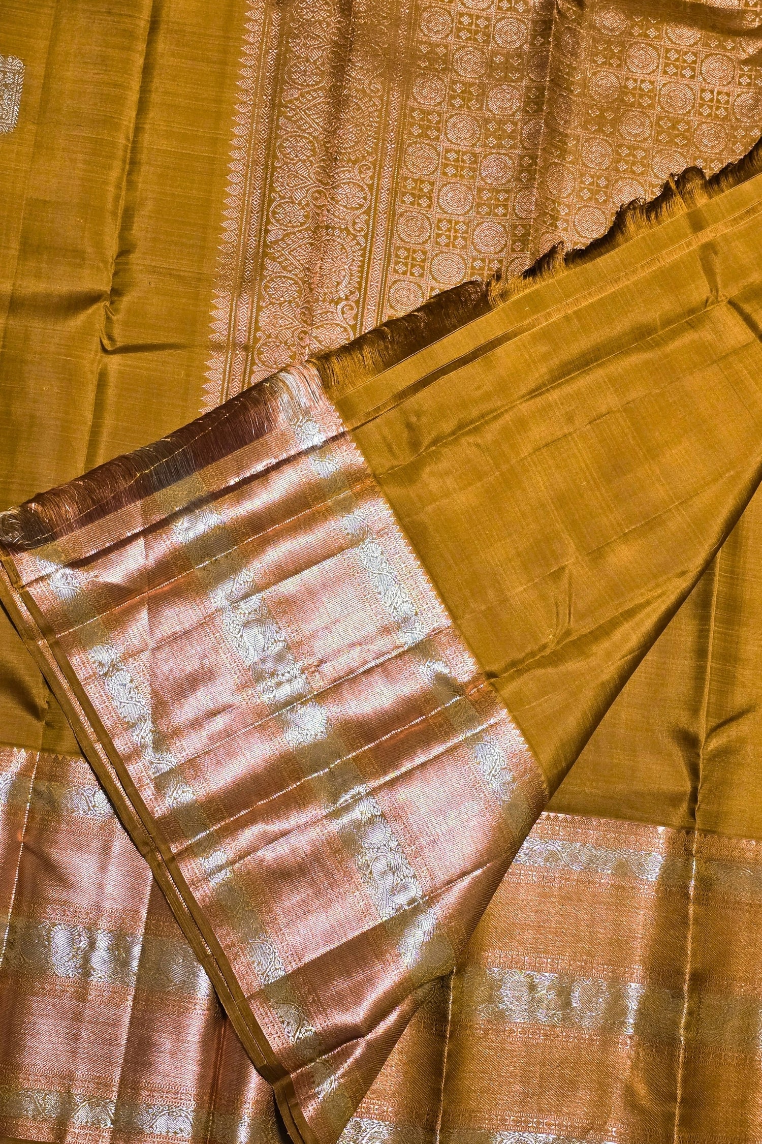 Close-up of a yellow saree with intricate patterns