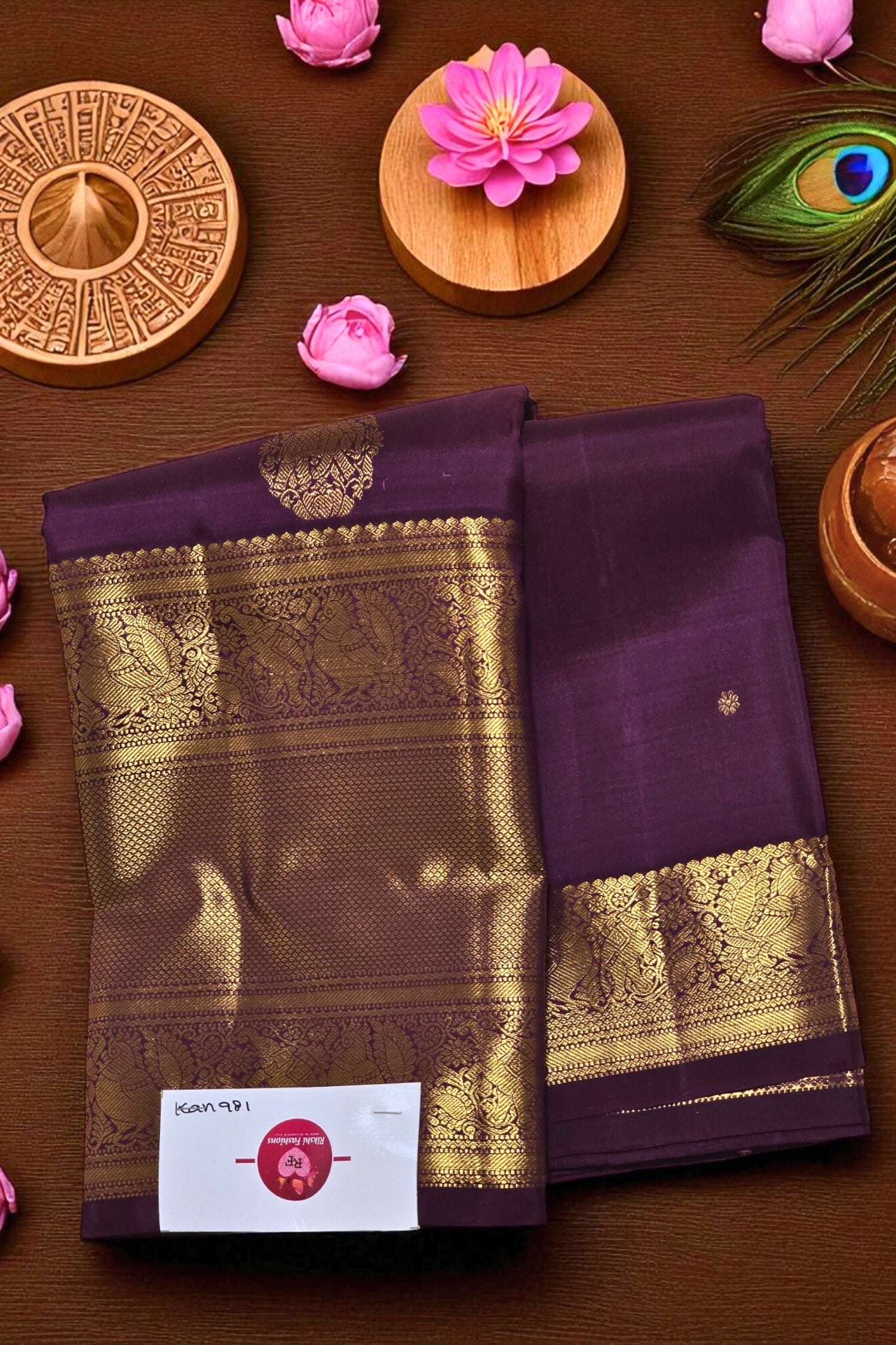 Purple and gold saree with decorative elements on a wooden surface