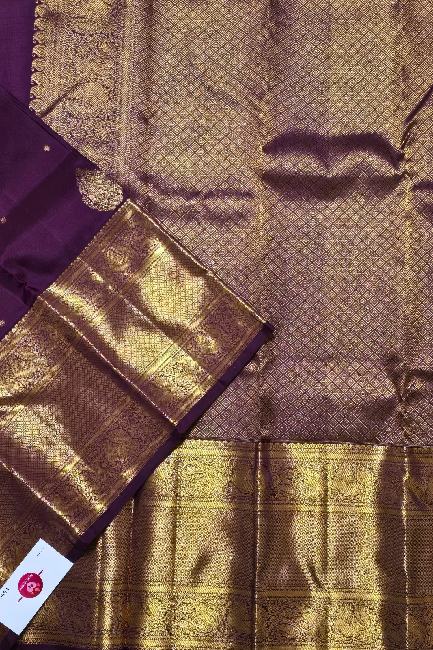 Close-up of a purple and gold saree with intricate patterns