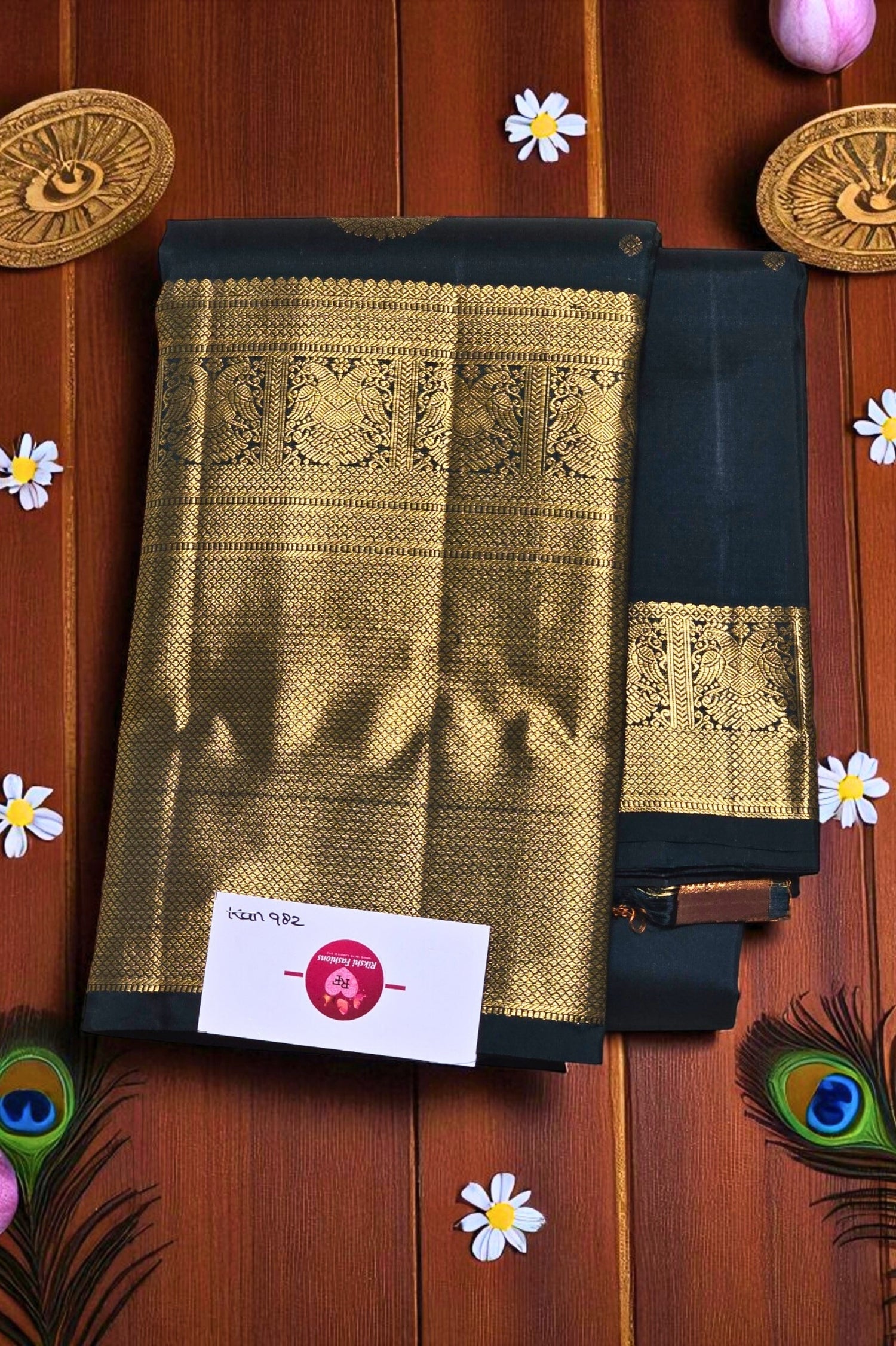 Black and gold saree with intricate patterns on a wooden background