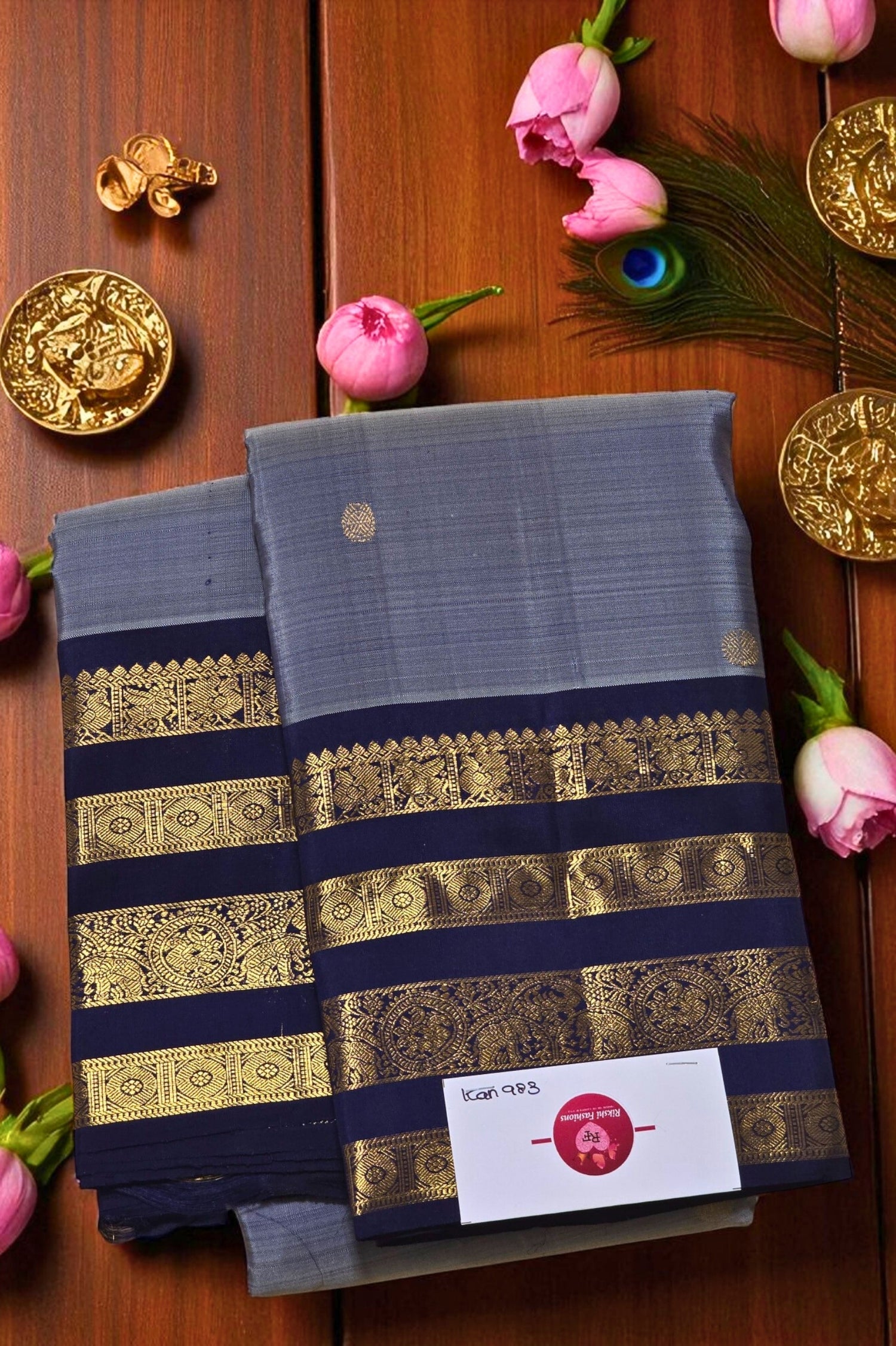 Blue saree with gold stripes on a wooden background with decorative elements