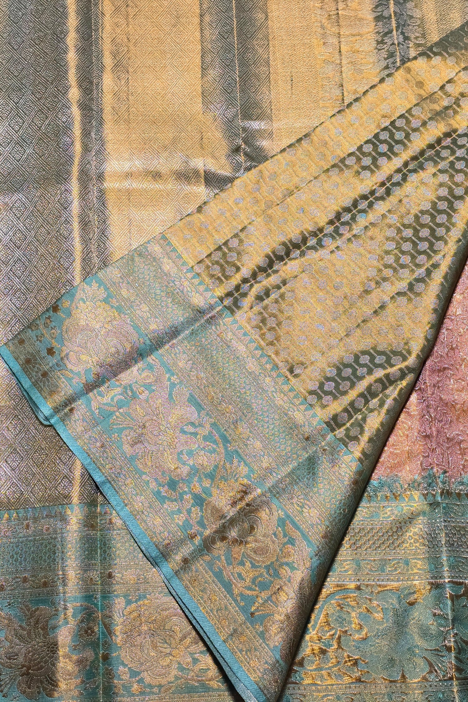 Close-up of a patterned fabric with blue, green, and beige colors.