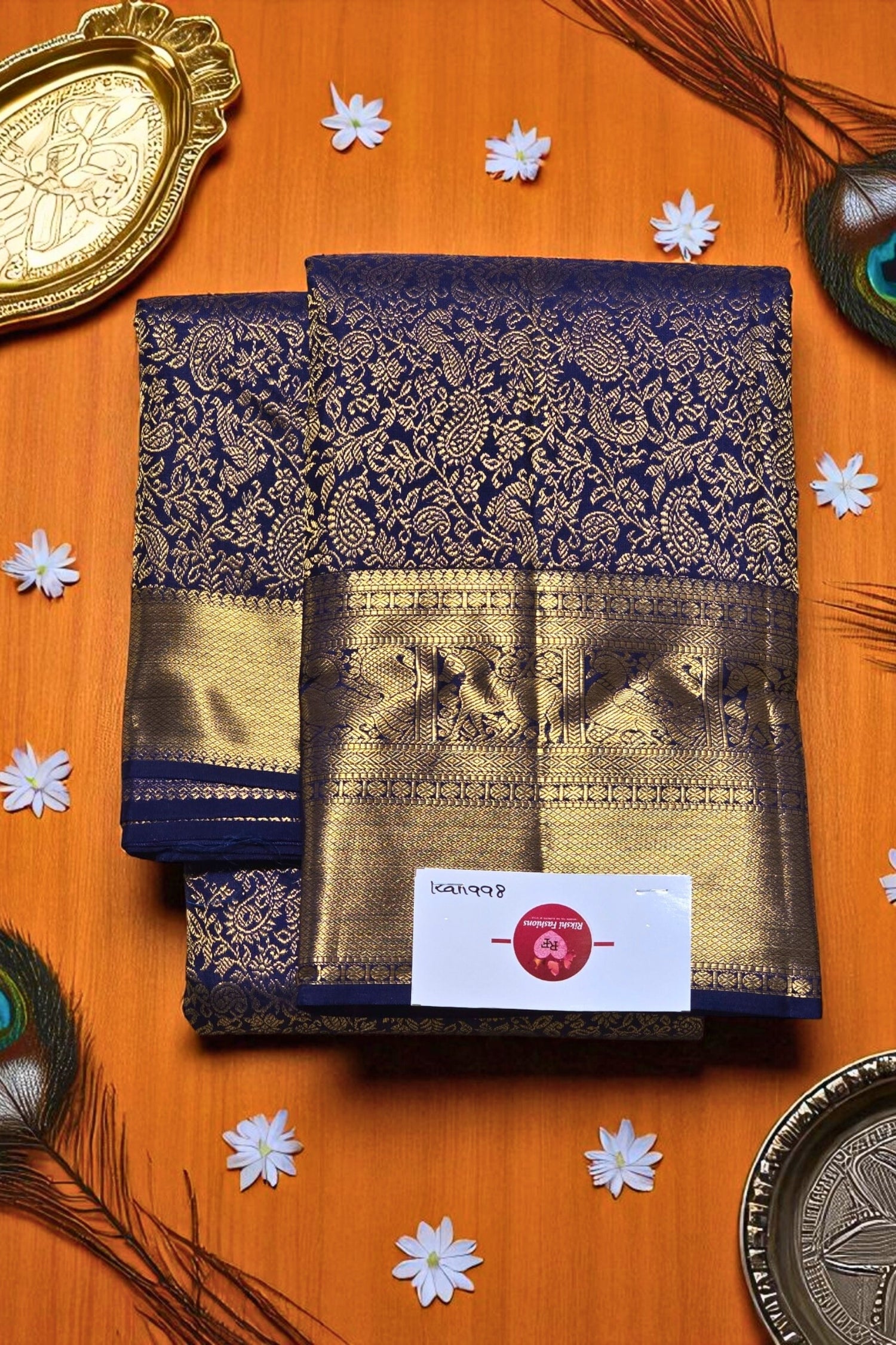 Navy blue and gold saree with a brand label on an orange background