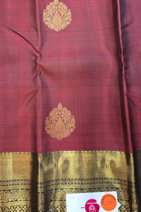 Maroon fabric with gold patterns and a visible brand label.