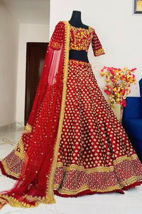 Red and gold traditional outfit on a mannequin with a white background