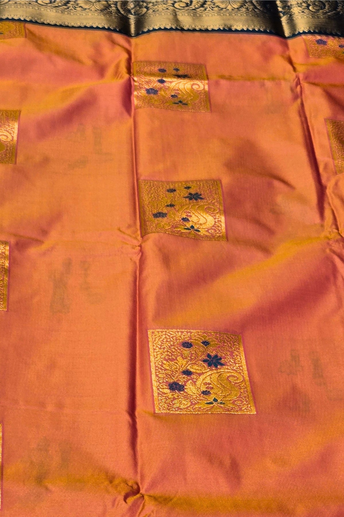 Traditional saree with gold embroidery on a pink background