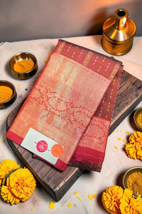 Traditional saree on a wooden board with yellow flowers and a small pot in the background