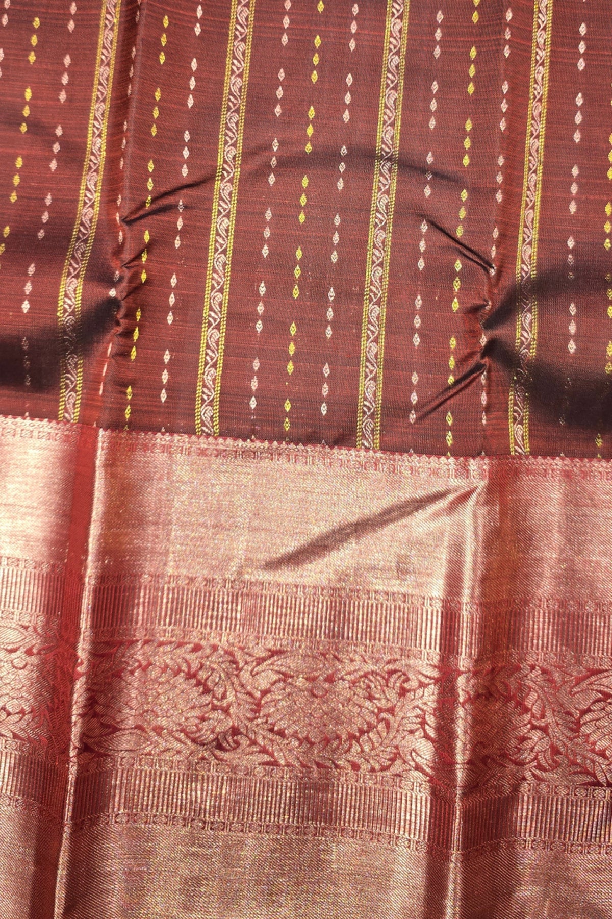 Close-up of a patterned fabric with red and gold colors