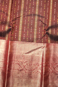 Close-up of a patterned fabric with red and gold colors