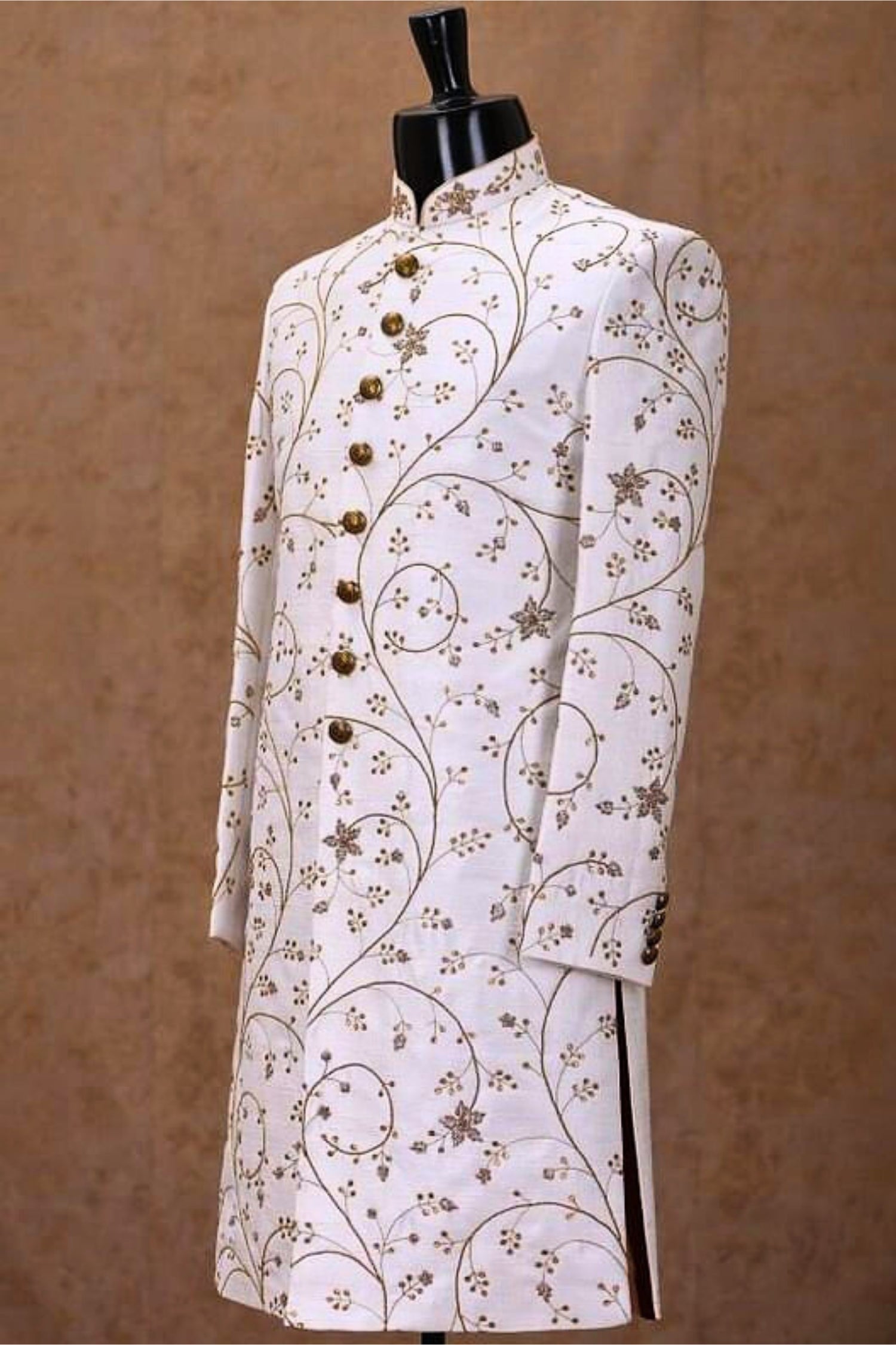 White embroidered jacket on a mannequin against a brown background