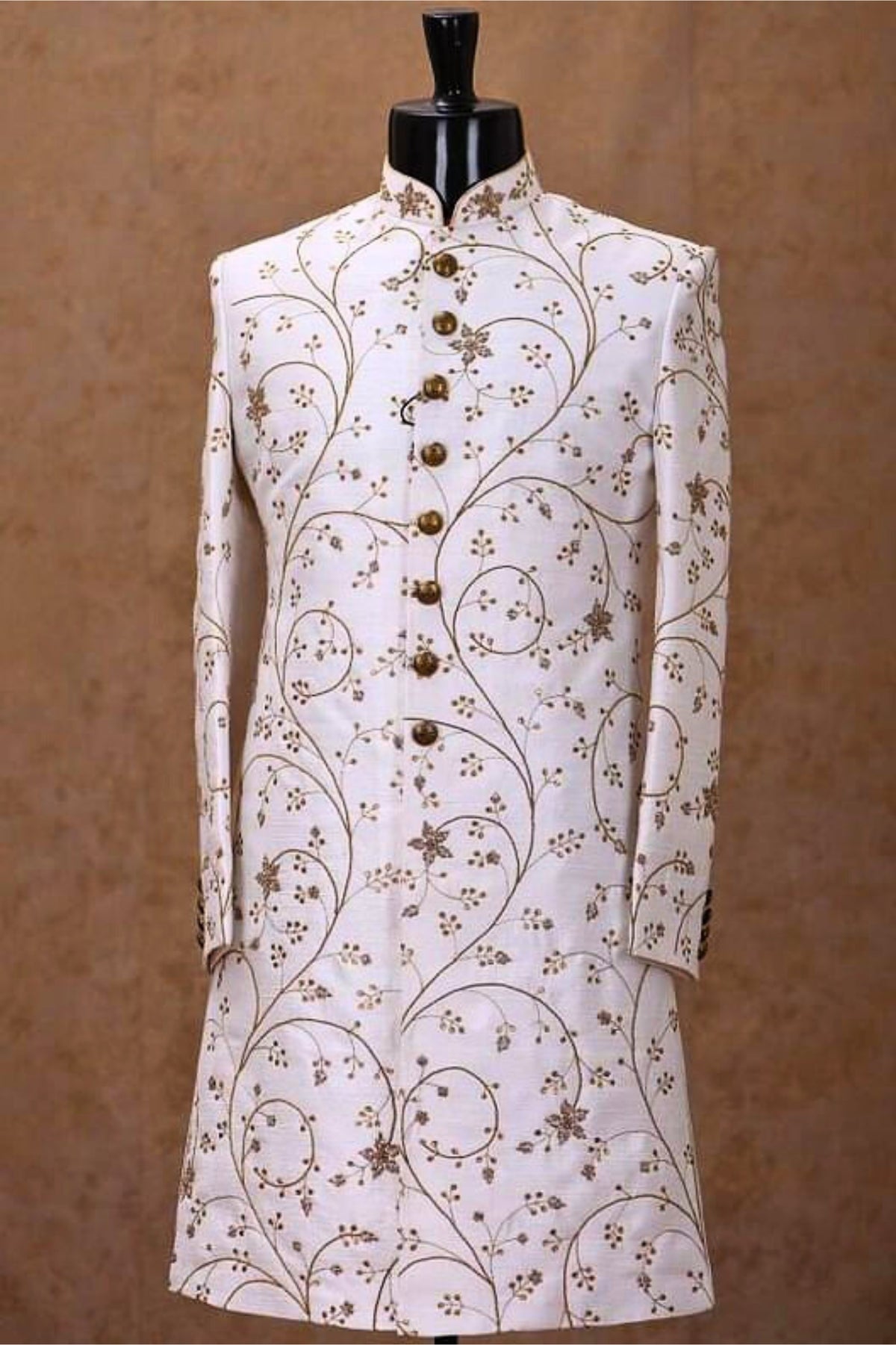 White embroidered jacket on a mannequin against a brown background