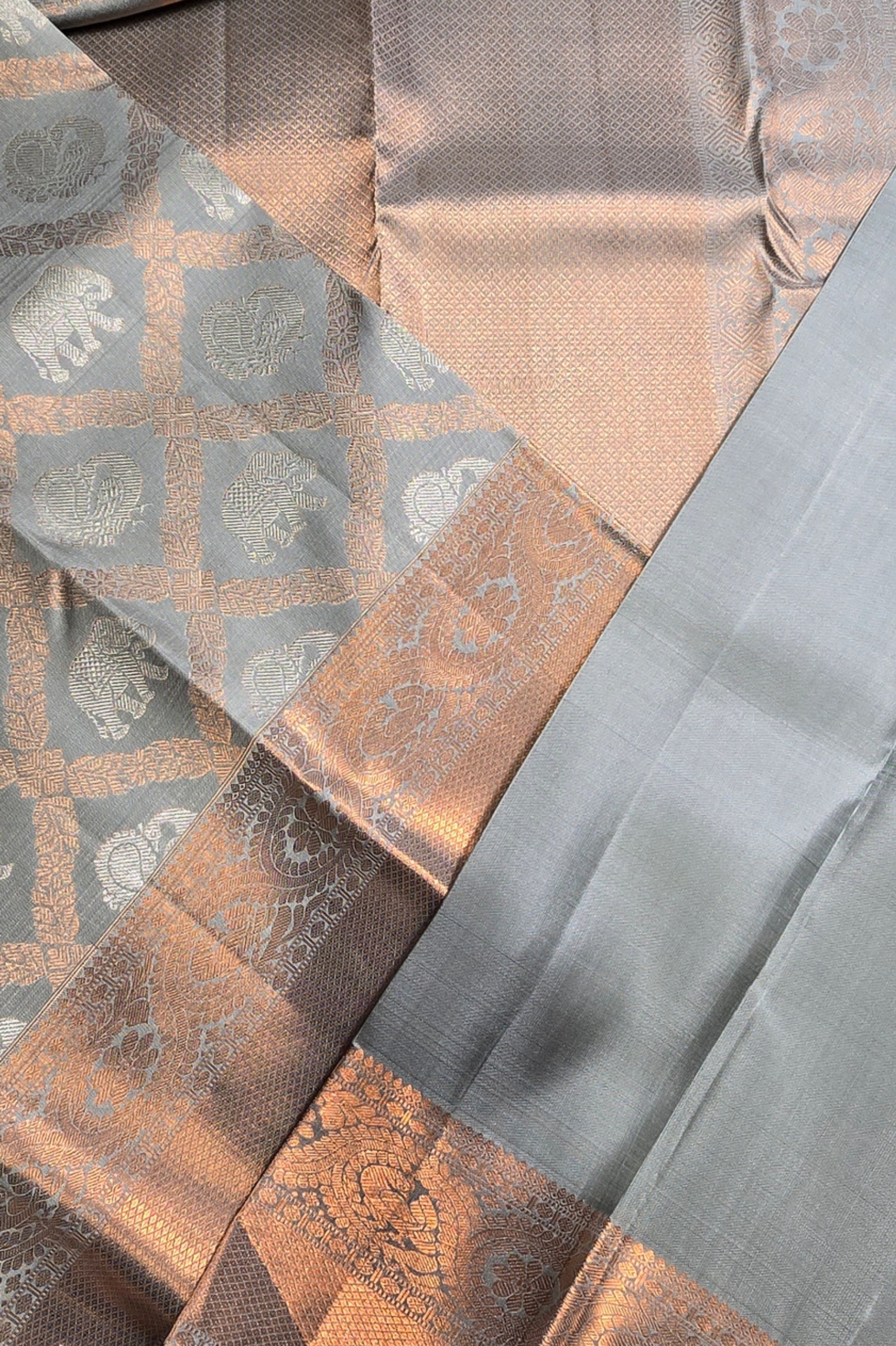 Close-up of patterned fabric with geometric design in brown, gray, and beige.