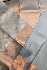 Close-up of patterned fabric with geometric design in brown, gray, and beige.