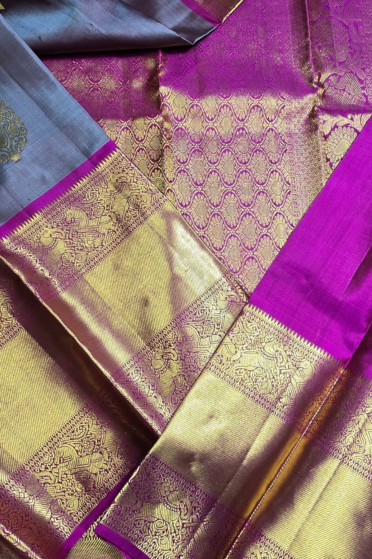 Close-up of a traditional saree with purple and gold patterns