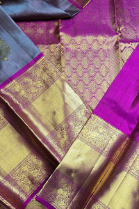 Close-up of a traditional saree with purple and gold patterns