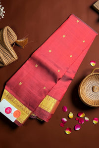 Red saree with gold border on a brown background