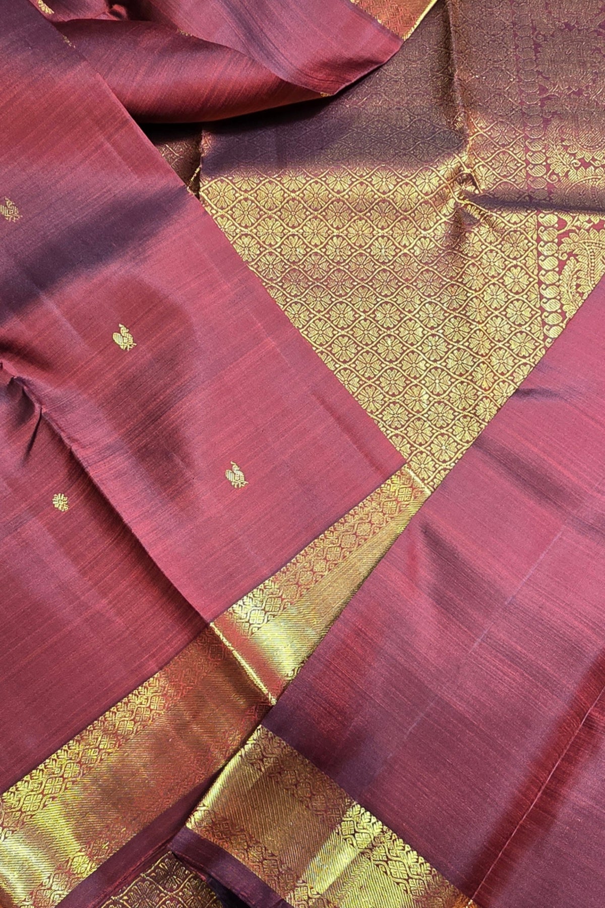 Maroon fabric with gold border and patterns