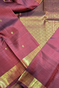 Maroon fabric with gold border and patterns