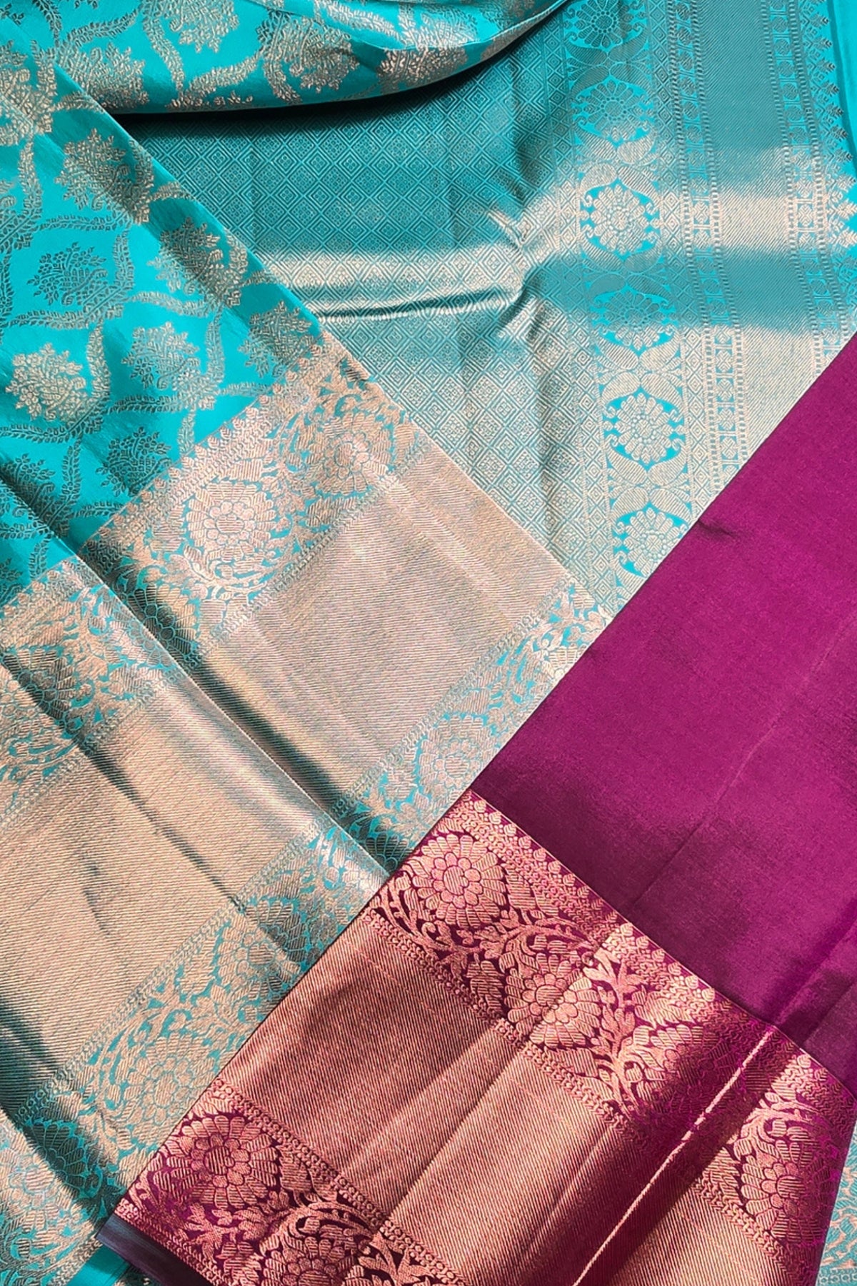 Close-up of a colorful fabric with turquoise, pink, and beige patterns.