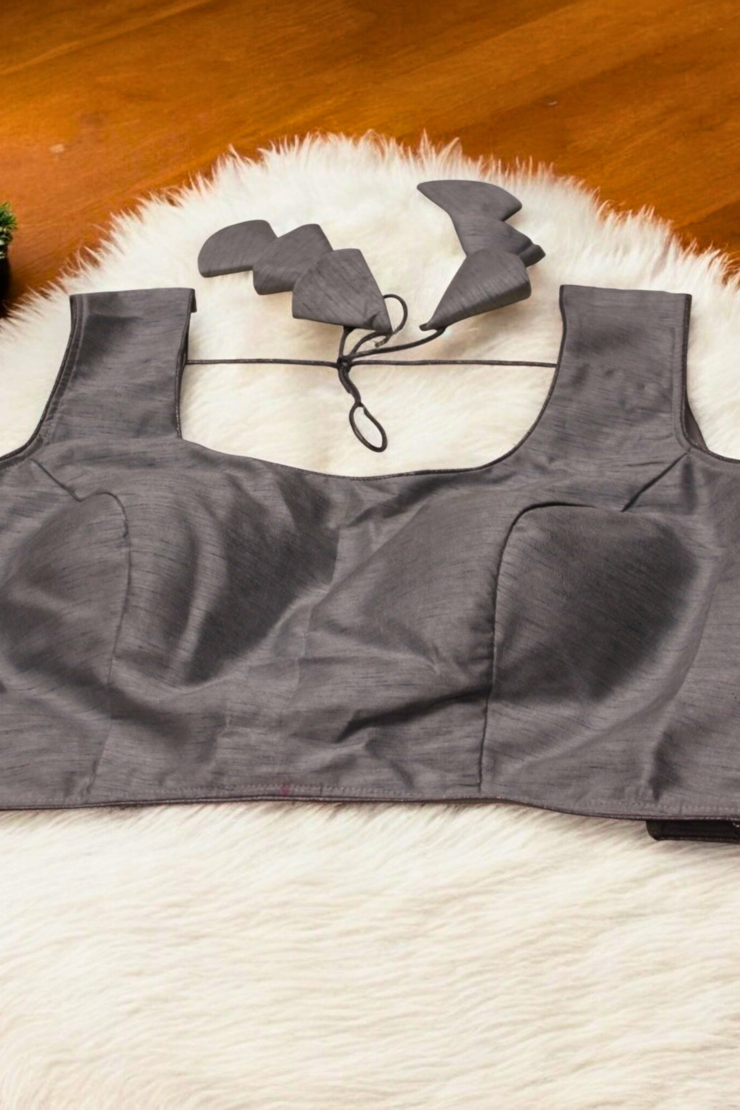 Gray sports bra with straps on a white surface