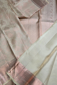 Close-up of a pink and white saree with intricate patterns