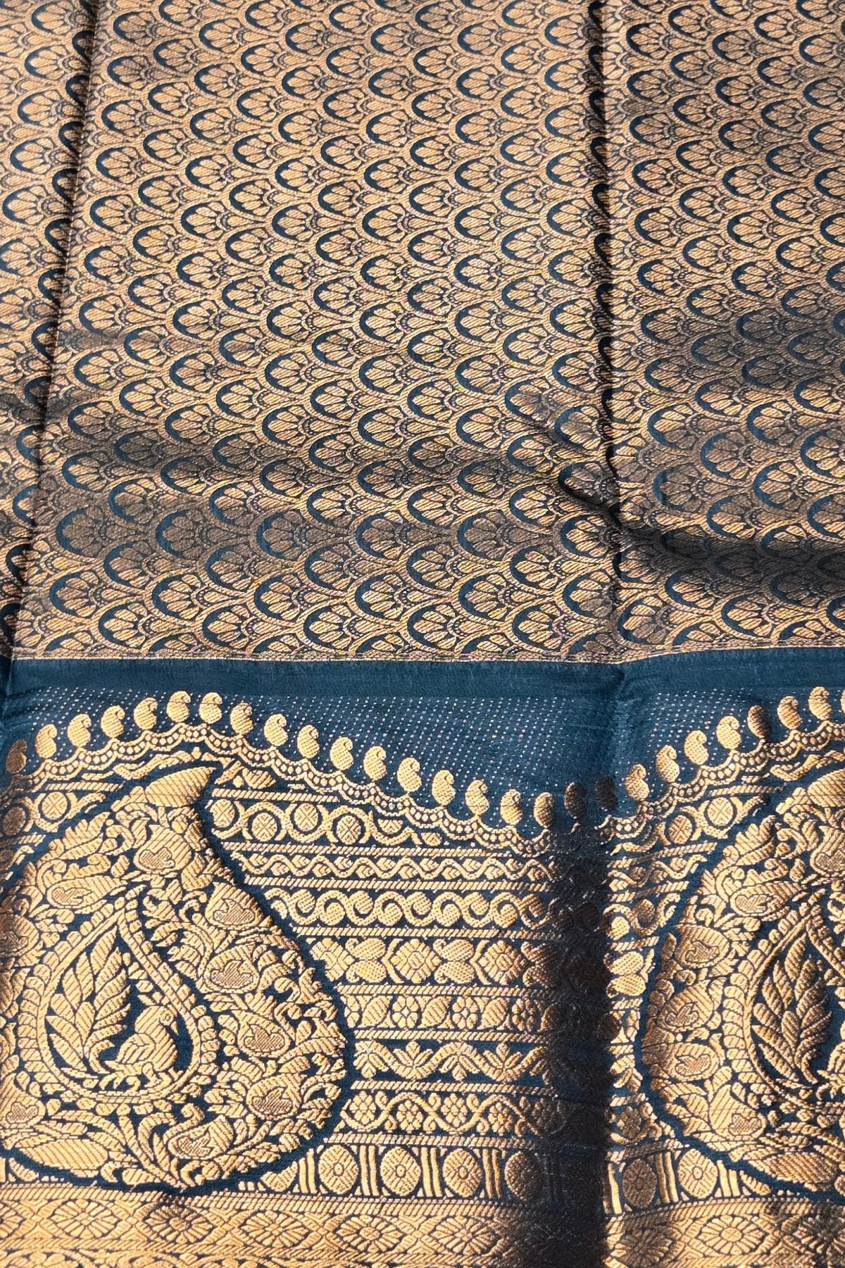 Close-up of a patterned fabric with gold and blue design