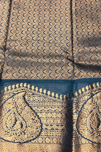 Close-up of a patterned fabric with gold and blue design
