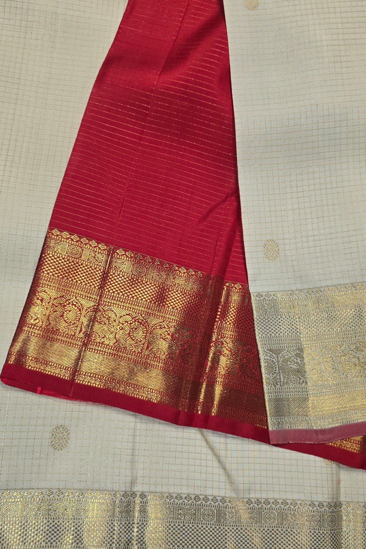 Red fabric with gold border on a beige background
