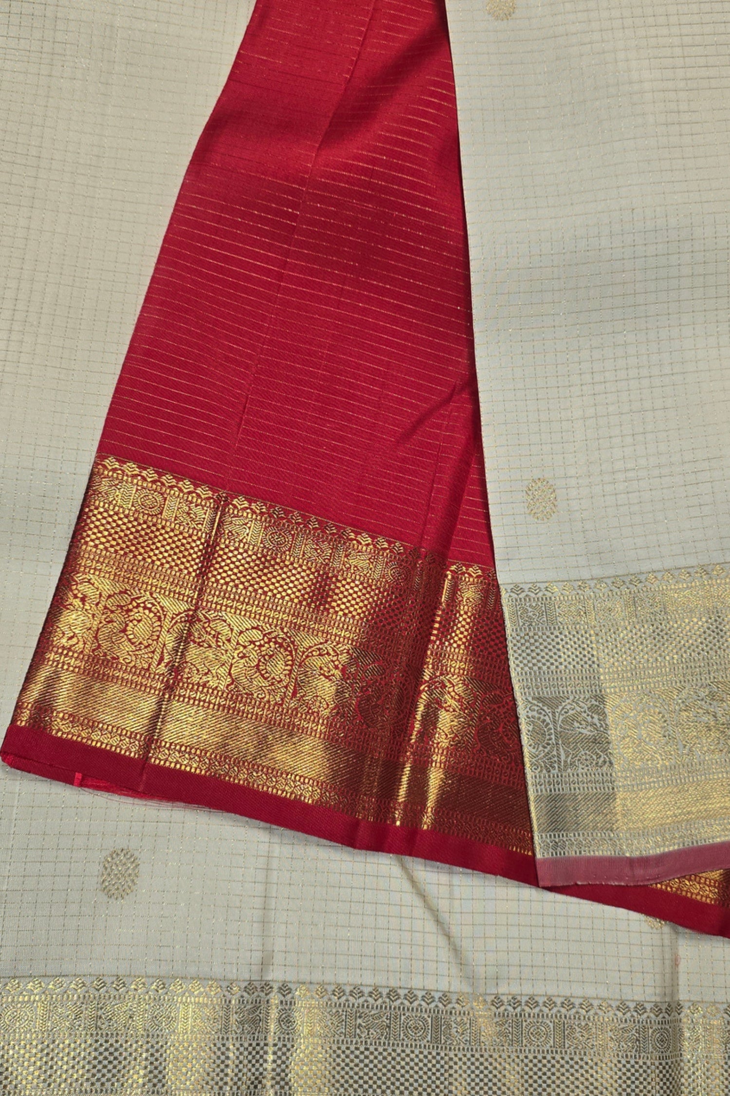 Red fabric with gold border on a beige background