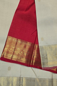 Red fabric with gold border on a beige background