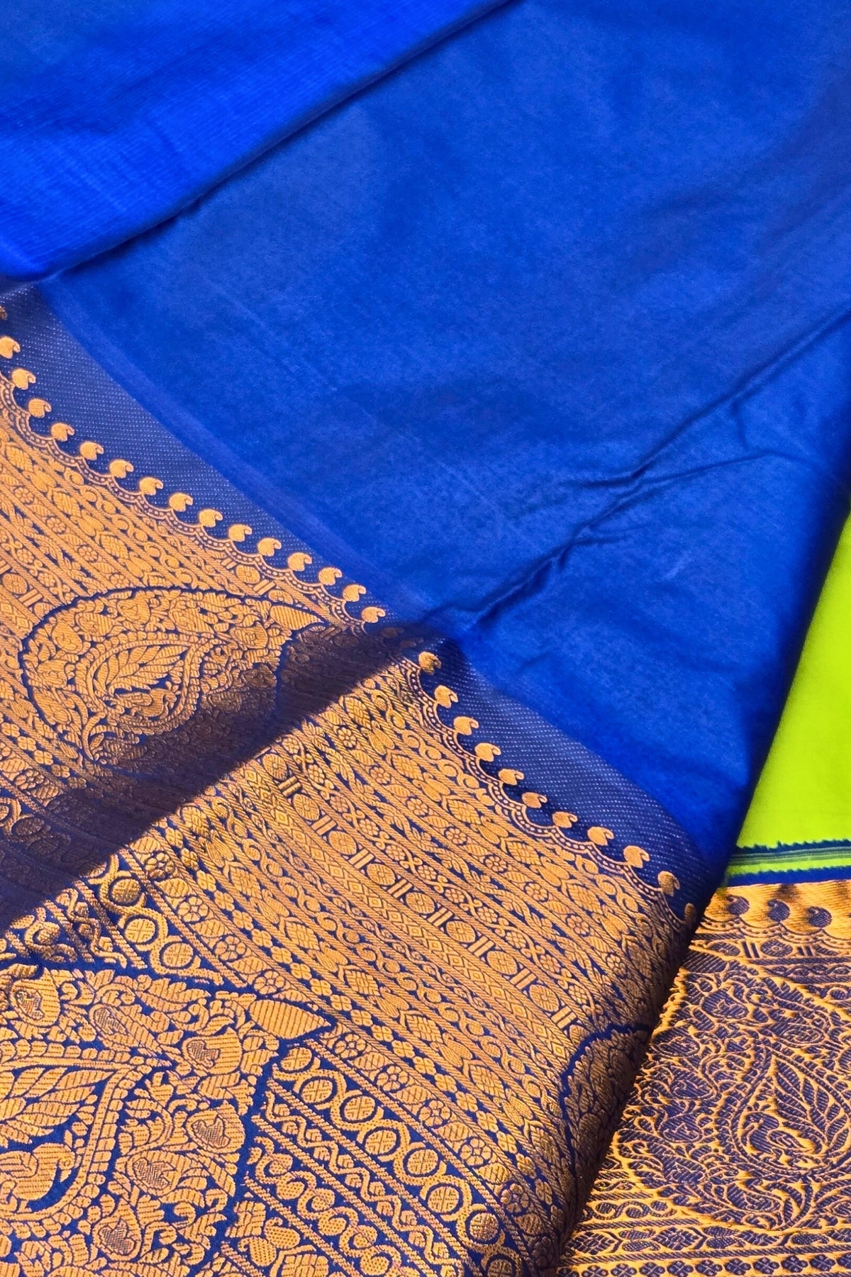 Blue fabric with gold embroidery and a green border