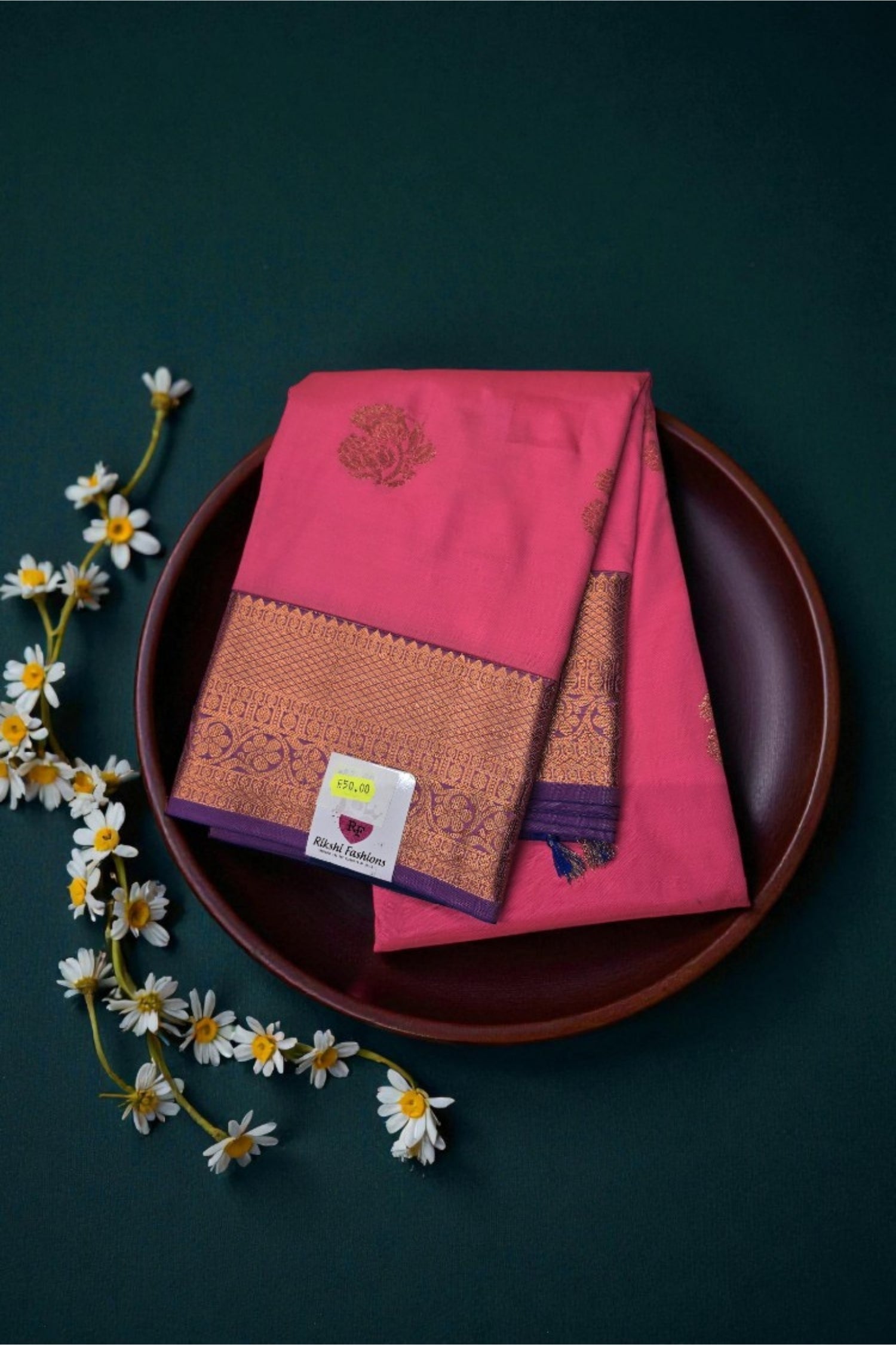 Pink saree with intricate patterns on a dark background