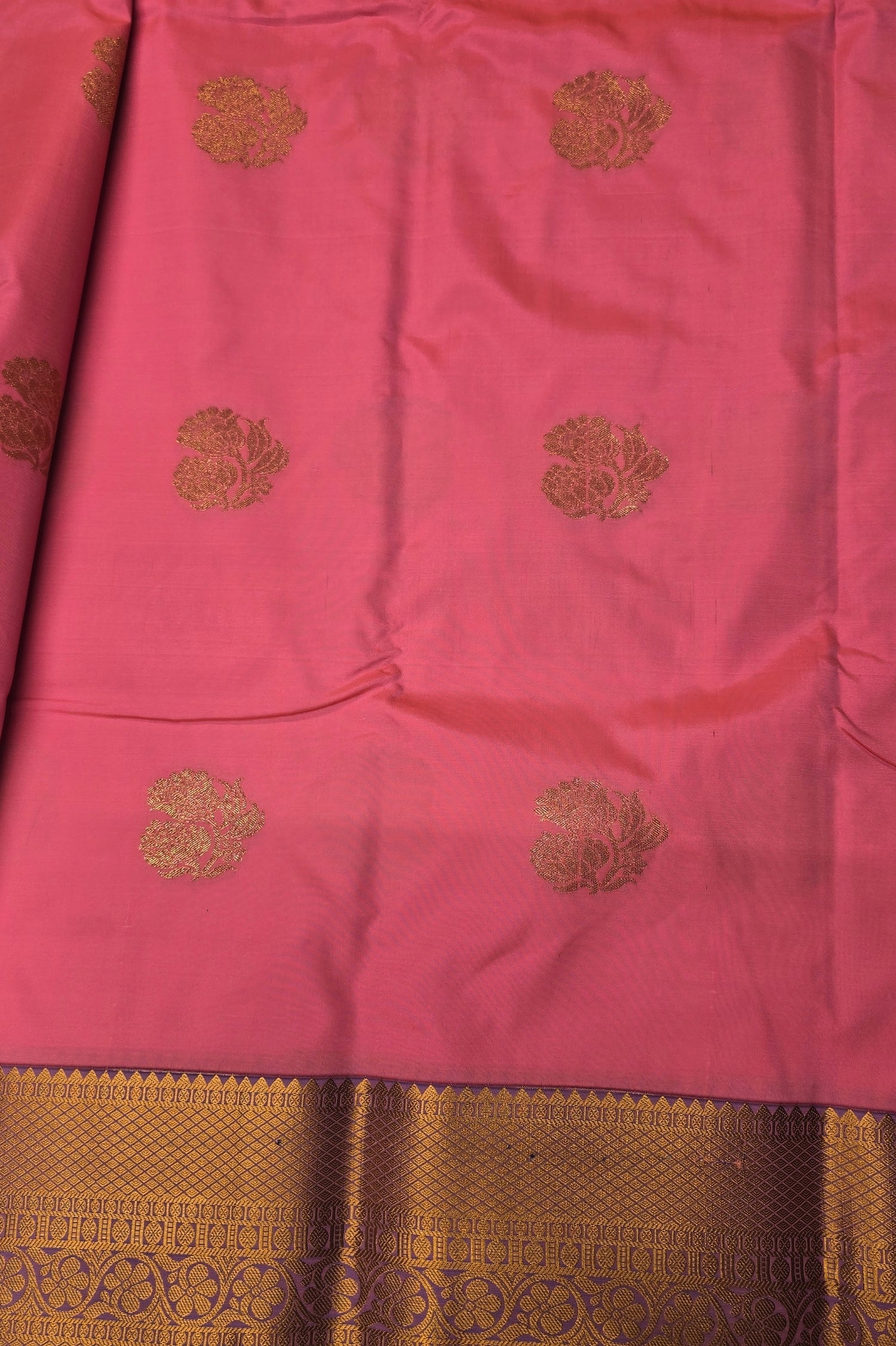 Pink fabric with gold embroidery and border