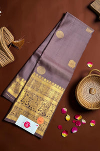 Brown saree with gold patterns on a brown background