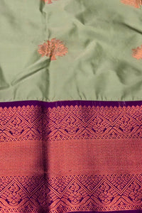 Green fabric with intricate red and purple patterns
