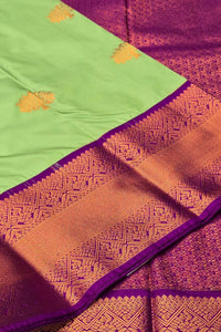 Saree with green, orange, and purple colors and intricate patterns.