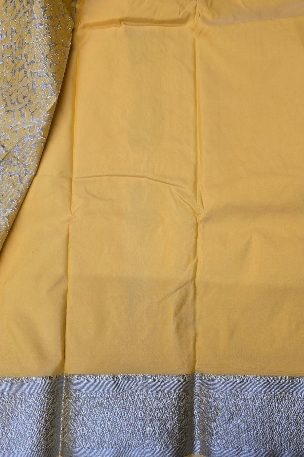 Close-up of yellow fabric with a blue border
